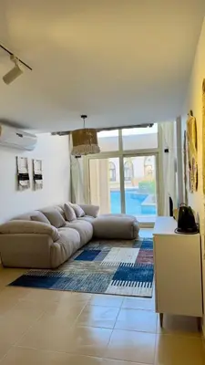 a living room with a couch and a large window at Kuba luxury loft in Hurghada