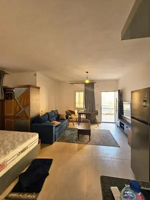 a living room with a couch and a table at Magawish Studio with Pool in Hurghada