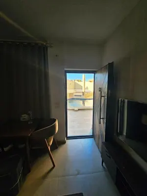 a living room with a door leading to a patio at Magawish Studio with Pool in Hurghada