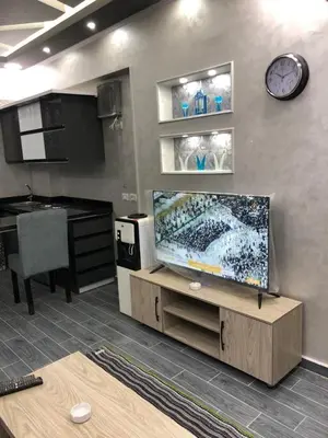 a living room with a flat screen tv on a wall at West Side Village in Hurghada