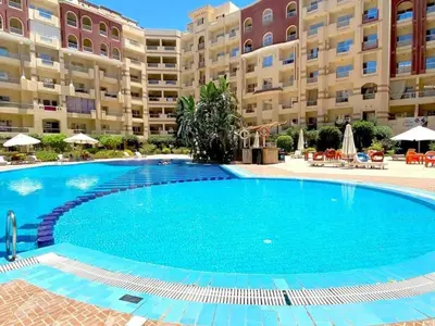 a large swimming pool in front of a large apartment building at Florenze J113 Hurghada in Hurghada