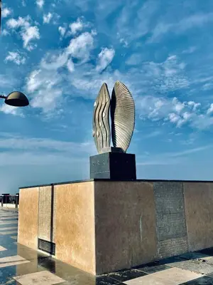 a statue in a parking lot with a blue sky at Florenze J113 Hurghada in Hurghada