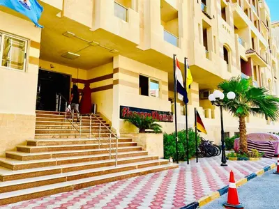 a building with stairs and flags in front of it at Florenze J113 Hurghada in Hurghada