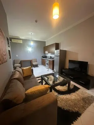 a living room with a couch and a table at Desert Pearl Lux in Hurghada