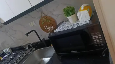 a kitchen counter with a microwave and a sink at Sea view Hotel Apartment in center in Hurghada