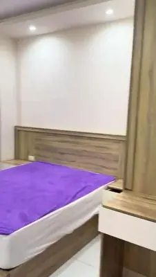 a bed in a room with a purple mattress at Moon Apartment Hurghada in Hurghada