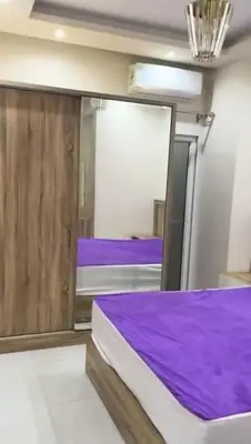 a bedroom with a purple bed and a mirror at Moon Apartment Hurghada in Hurghada
