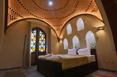 a bedroom with a large bed with an arched ceiling at Saray ElOmda Wellness - Retreat Village in Al Karnak