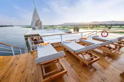 a deck of a boat with lounge chairs on it at Azhar II Dahabiya Luxury Nile Cruise in Luxor