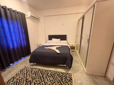 a small bedroom with a bed and a window at Lokanda lodge&Apartments in Luxor