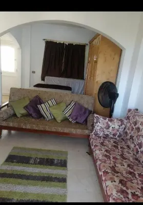 a living room with a couch and a bed at Luxur sleep in Al Baghdādī