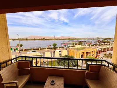 a balcony with a view of a body of water at Jewel Luxor Hotel Nile View in Luxor