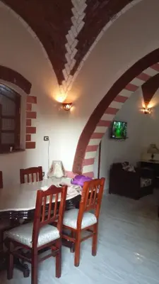 a dining room with a table and two chairs at The Nile Dome Garden Suite in Luxor