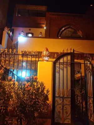 a building with an iron gate and a restaurant at The Nile Dome Garden Suite in Luxor