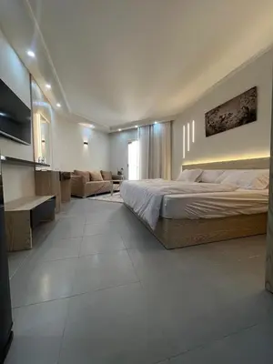 a large bedroom with a bed and a couch at Scandic Resort Sea View Room in Hurghada