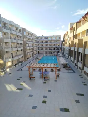 a swimming pool in the middle of a apartment building at Princese Resort Beach 1ST Avenue SouthSide in Hurghada