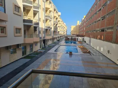 an empty corridor of an apartment building at Modern Pool View 1BR with Balcony Prime Location on Hurghada Vibrant Promenade in Hurghada