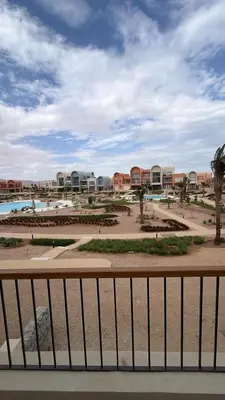 a view of a resort with a pool and buildings at Kamaran 2BR Retreat in Hurghada