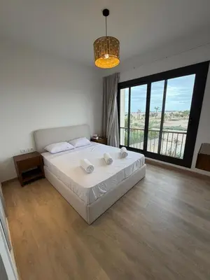 a bedroom with a large bed and a large window at Kamaran 2BR Retreat in Hurghada