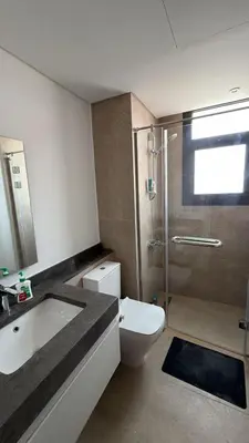 a bathroom with a toilet and a sink and a shower at Kamaran 2BR Retreat in Hurghada