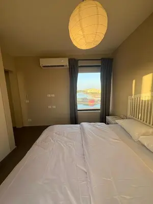 a large white bed in a bedroom with a window at Chic condo at Tawila 1BR El Gouna in Hurghada