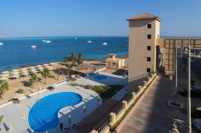 a view of a resort with a pool and the ocean at كمباوند ذا فيو The View Compound in Hurghada