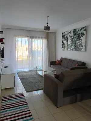 a living room with a couch and a glass table at كمباوند ذا فيو The View Compound in Hurghada