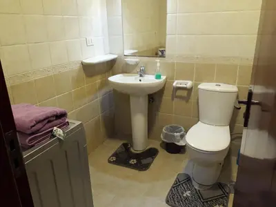 a bathroom with a toilet and a sink at كمباوند ذا فيو The View Compound in Hurghada