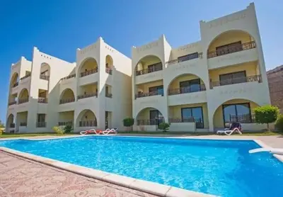 a large building with a swimming pool in front of it at كمباوند ذا فيو The View Compound in Hurghada