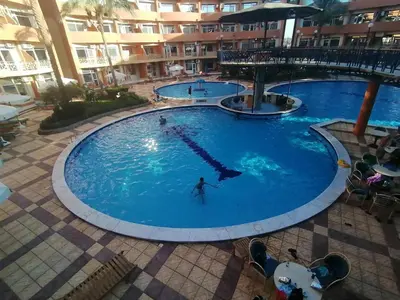 a large swimming pool with a person in the water at oasis resort ,areada HRG in El Gouna