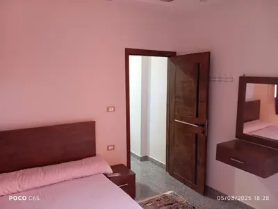 a bedroom with a bed and a mirror at oasis resort ,areada HRG in El Gouna
