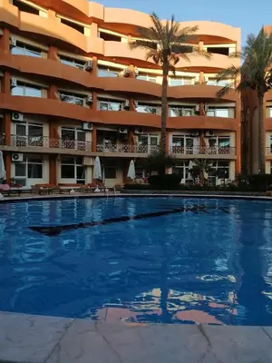 an empty swimming pool in front of a hotel at oasis resort ,areada HRG in El Gouna