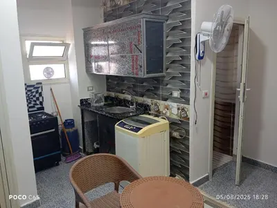a kitchen with a sink and a counter with a fan at oasis resort ,areada HRG in El Gouna