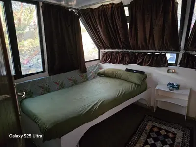a small bed in a room with windows at The Grand in Aswan