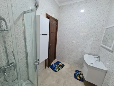 a bathroom with a shower and a toilet and a sink at Golden Home Hurghada in Hurghada
