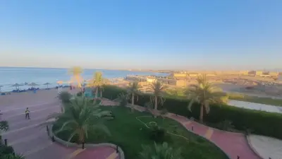 an aerial view of a park with palm trees and the ocean at Cecelia Resort Hurghada in Hurghada
