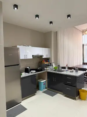 a kitchen with white cabinets and a stainless steel refrigerator at Tawila villa 14 in Hurghada