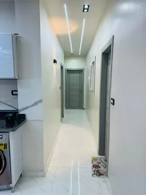 a hallway leading to a kitchen with a door at شقة بالانتر الغردقة in Hurghada