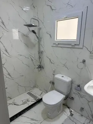 a white bathroom with a toilet and a sink at شقة بالانتر الغردقة in Hurghada