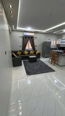 a living room with a couch and a table at شقة بالانتر الغردقة in Hurghada