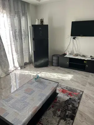 a living room with a table and a tv at Selena bay hurghada in Hurghada