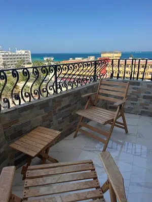 two wooden benches sitting on top of a balcony at Red Sea view in Hurghada