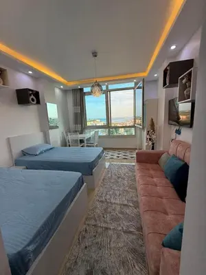a bedroom with two beds and a couch at AL Andalusia Hurghada in Hurghada