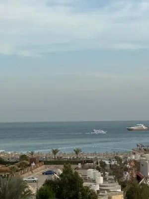 a view of a beach with a cruise ship in the water at AL Andalusia Hurghada in Hurghada