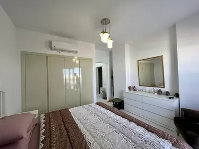 a white bedroom with a bed and a mirror at Swan Lake 3BR with Roof & Terrace in Hurghada