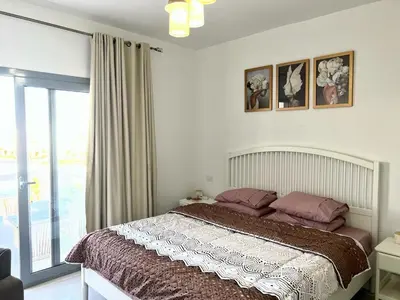 a bedroom with a bed and a large window at Swan Lake 3BR with Roof & Terrace in Hurghada
