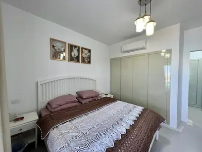 a bedroom with a large bed with purple pillows at Swan Lake 3BR with Roof & Terrace in Hurghada