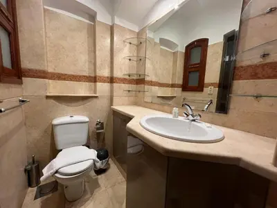 a bathroom with a toilet and a sink at Lagoon-Front 3BR Townhouse in Upper Nubia in Hurghada