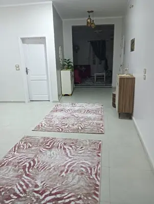 a hallway with two rugs on the floor in a room at noreno houseاسوان شياخة تانية طريق السادات in Aswan