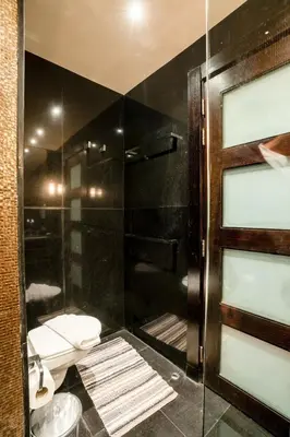 a bathroom with a glass shower with a toilet at Private Ali Pasha 2BR Pool Access + Dining Perks in Hurghada